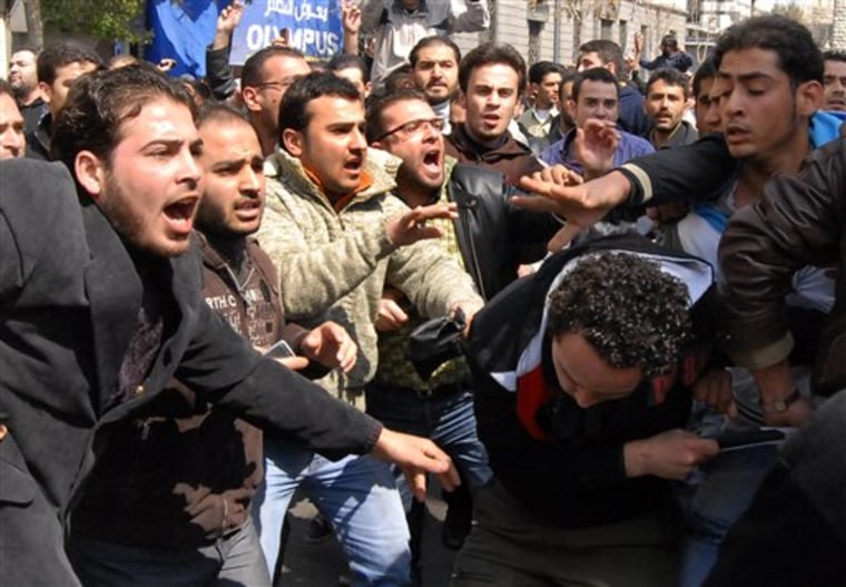 Anti-Syrian government protesters, left, and pro-government, right, clash after Friday prayers in Damascus. 